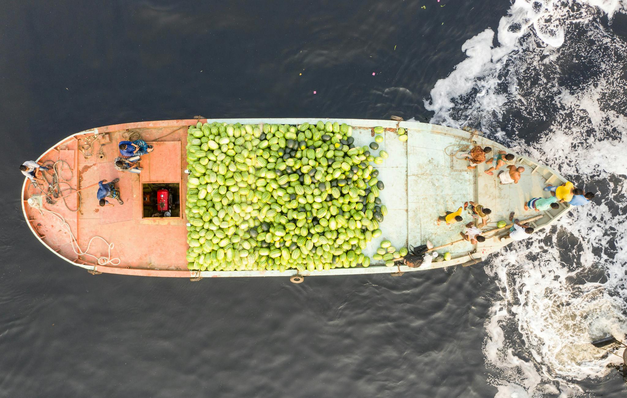High-angle view of a boat transporting watermelons on the sea.